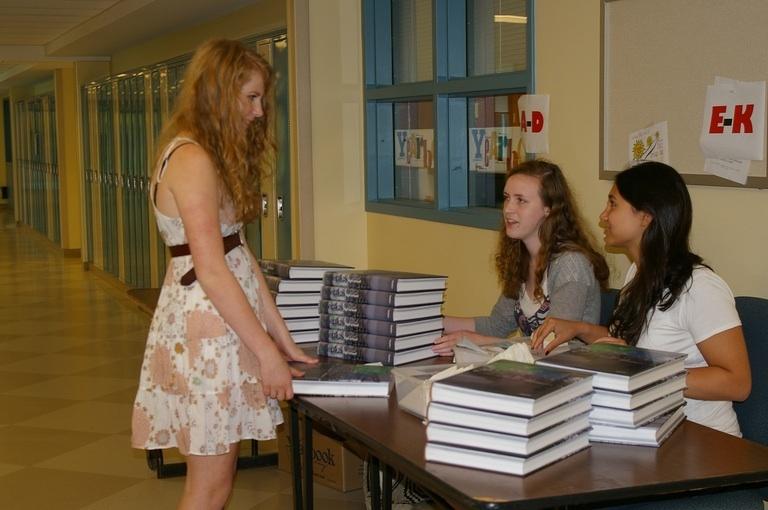 Pippa Hazlewood 11 picks up her 2009 yearbook at the distribution table. Photo by Devin Skolnick 11