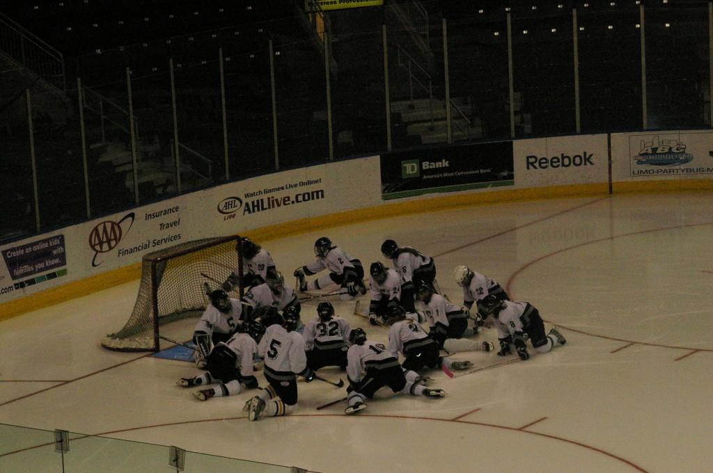 The girls Ice Hockey team strategizes before the game starts. | Photo by Kate McNee 11.