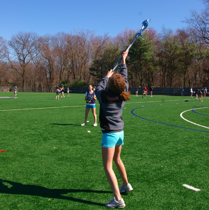 Jess Adrian 13 reaches to catch a pass as she warms up for tryouts. | Photo by Carlie Schwaeber 12
