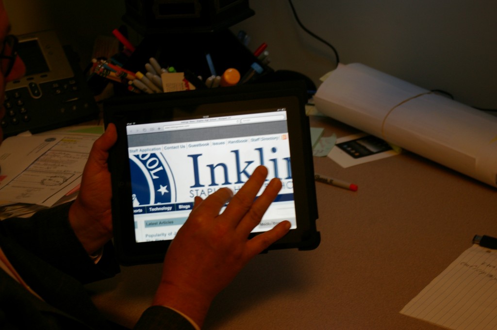 CAUGHT: Science 6-12 Coordinator AJ Sheetz checks out the Inklings website on the iPad. | Photo by Sammy Warshaw '12