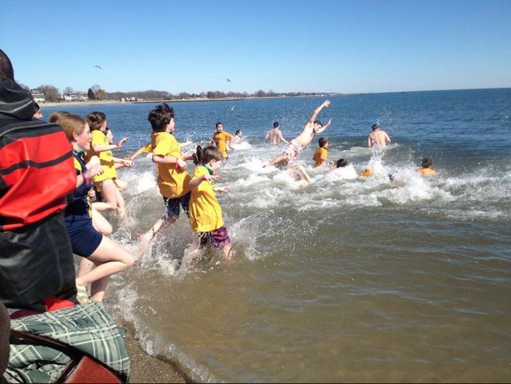 Some younger participants jump into the frigid waters at the Penguin Plunge.