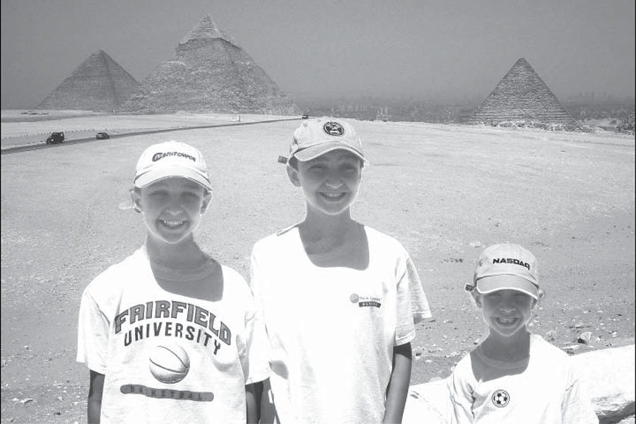 Too dangerous to travel: Massoud and his younger brothers pose near the pyramids during their last
family trip to Egypt in 2009. The violence has prevented families like Massoud’s from returning.