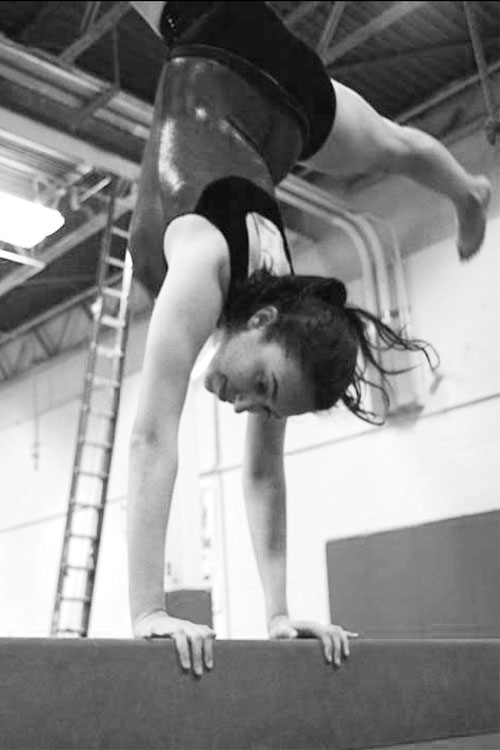 Balancing Act: Deanna Baris ’14 practices on the balance beam at
Arena Gymnastics.