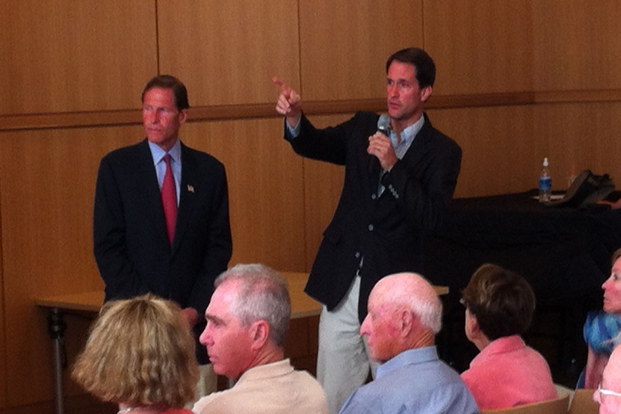 Rep. Jim Himes addresses a speaker from the audience at Sunday’s public meeting on Syria. 