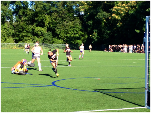 Staples defense played their hardest against Warde’s strong offensive line. Here goalie Jodie Baris ‘15 took a tumble in attempts of stopping a goal. Talk about commitment.