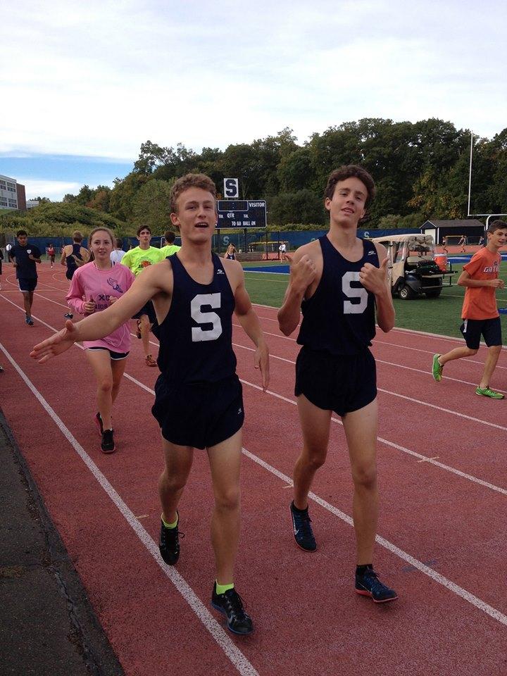 Varsity runers Oliver Hickson, '15, and Jack Berman '15 jog a few warm up laps before their race.