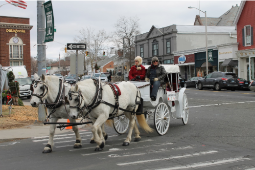 The Westport Downtown Merchants Association, sponsors of the event, cart Westport citizens in an old fashioned horse and buggy on Dec. 13 and 14.  
