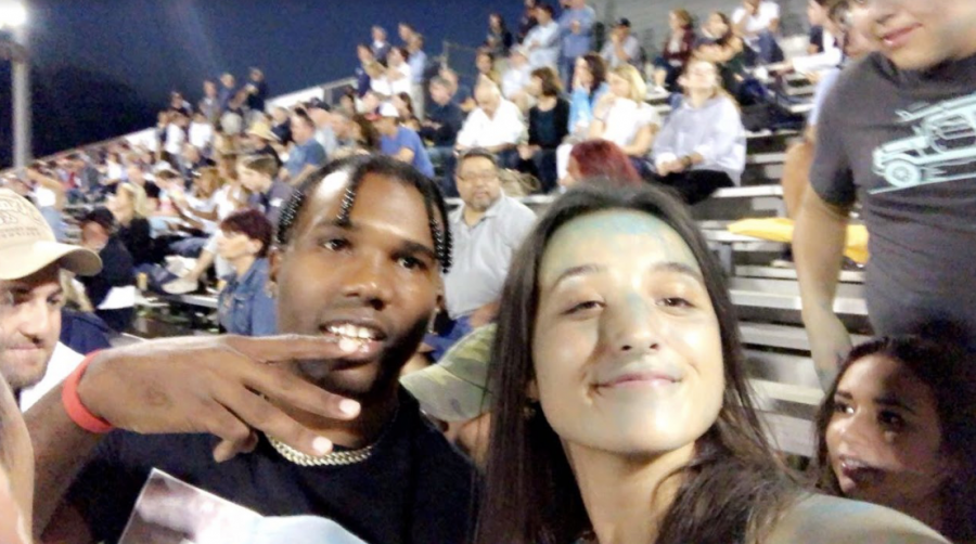 Yalee is a 25-year-old rapper, singer, songwriter and performer. Michelle Kaminski 21 poses with Yalee at the football game on Sept. 28