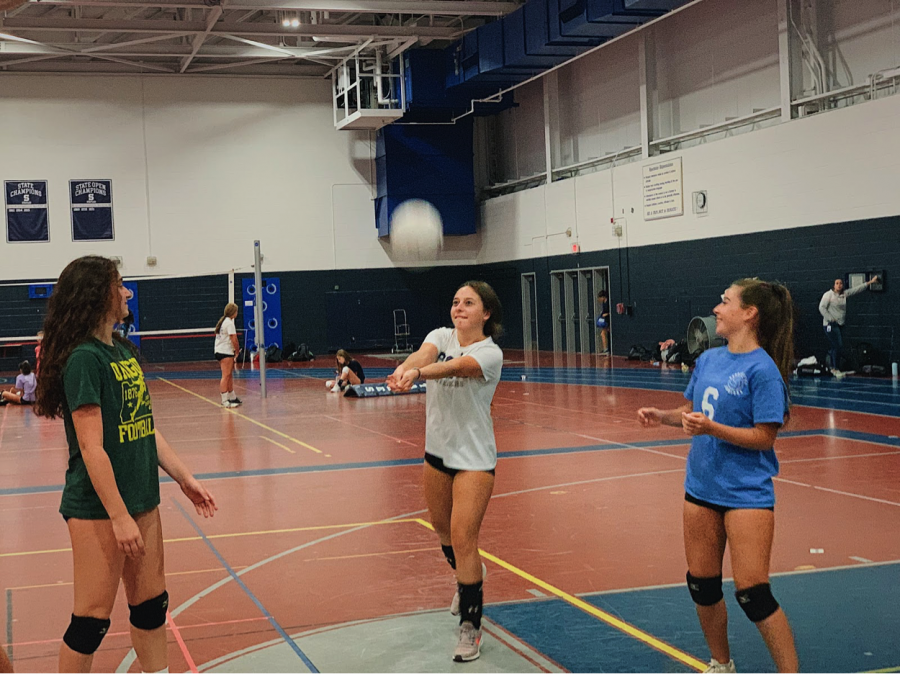 Staples sophomores (from left) Layla Bloomingdale, Karina Murray and Chloe Murray warm-up for their volleyball practice that is over two hours every day. After their workout, they must go home to do hours of homework.
