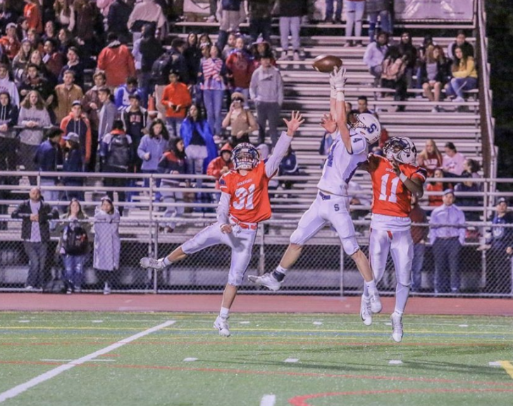 Ryan Thompson ’22 makes a miraculous grab over two defenders in the third quarter bringing Staples to the McMahon one yard-line. 
