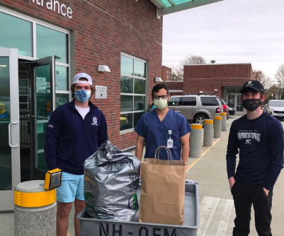 Staples wrestling team captains Nick Augari ’22 and Gerard Dallen ’22 deliver Feed It Forward donations to Norwalk Hospital.