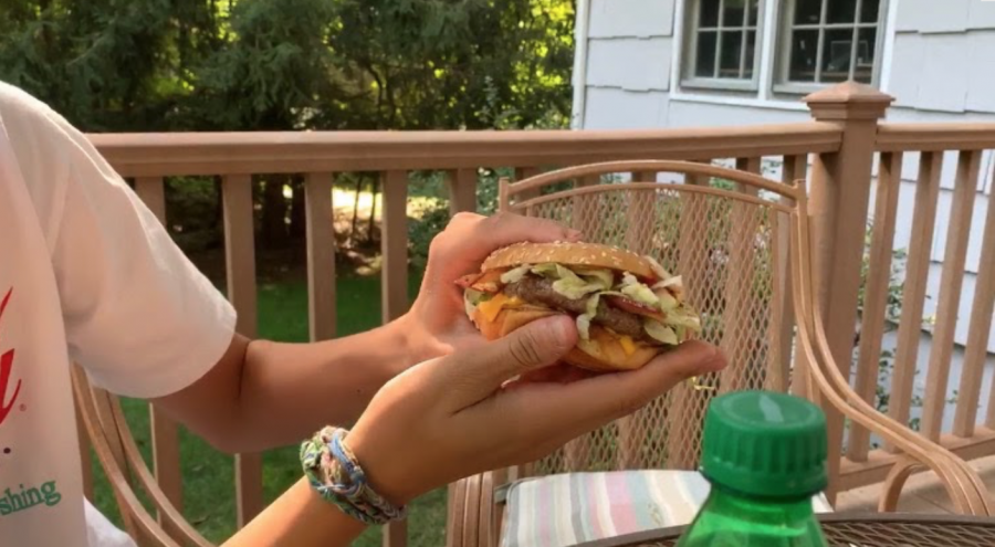 As Pictured, the burger in The Travis Scott Meal includes: onions, pickles, two slices of cheese, ketchup, and mustard.
