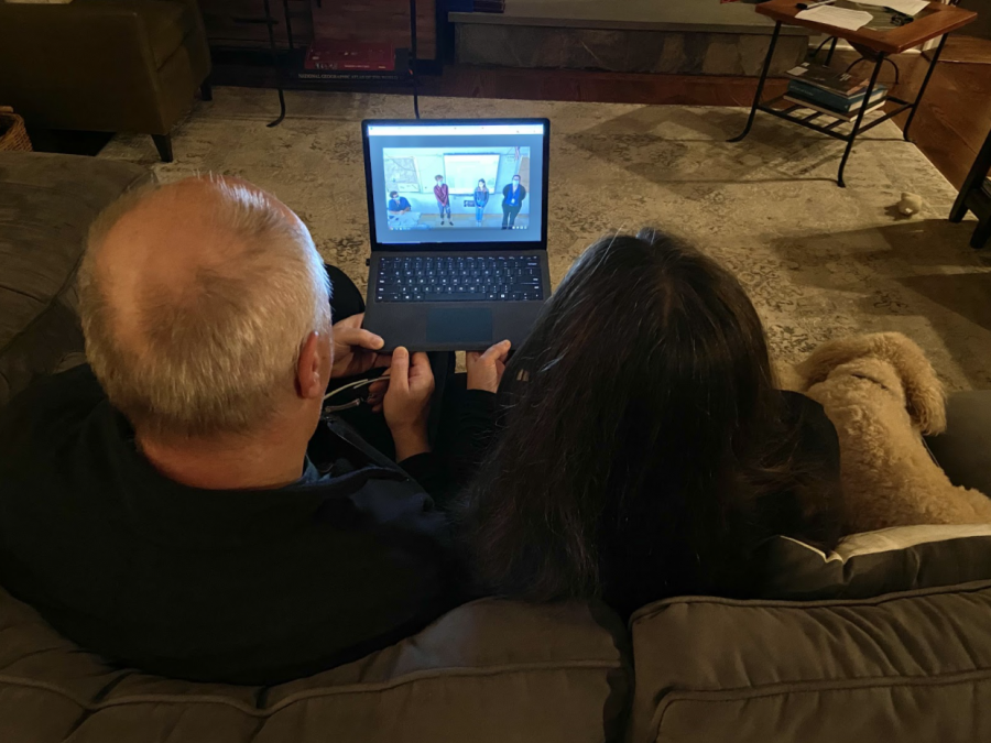 Staples parents Holly Rogers (right) and Zoran Hruskar (left) watch virtual back to school night presentations from the comfort of their home. As a precaution to stay safe from COVID-19, teachers pre-recorded or streamed their presentations live through zoom. 