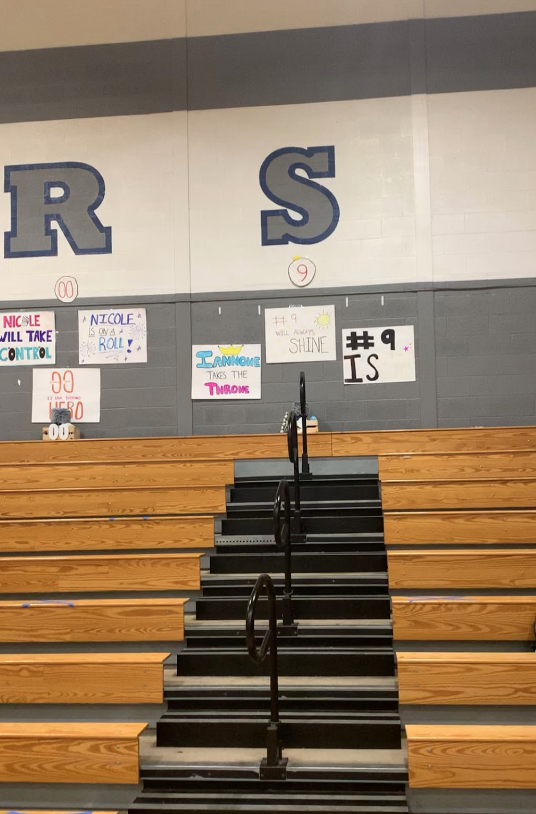 Posters are hung up in the volleyball gym for the seniors before their senior night home game. 