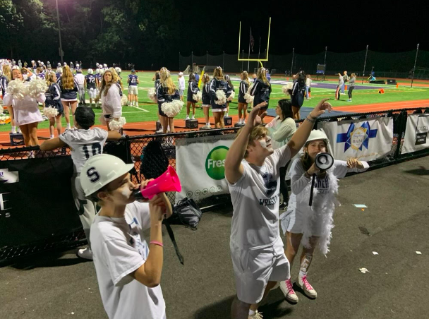 Superfan Captains lead the school spirit at all school sporting events. Here they rally the fan section at the last Staples football game on Sept. 17 vs St. Joseph. The Wreckers lost 35-14.
