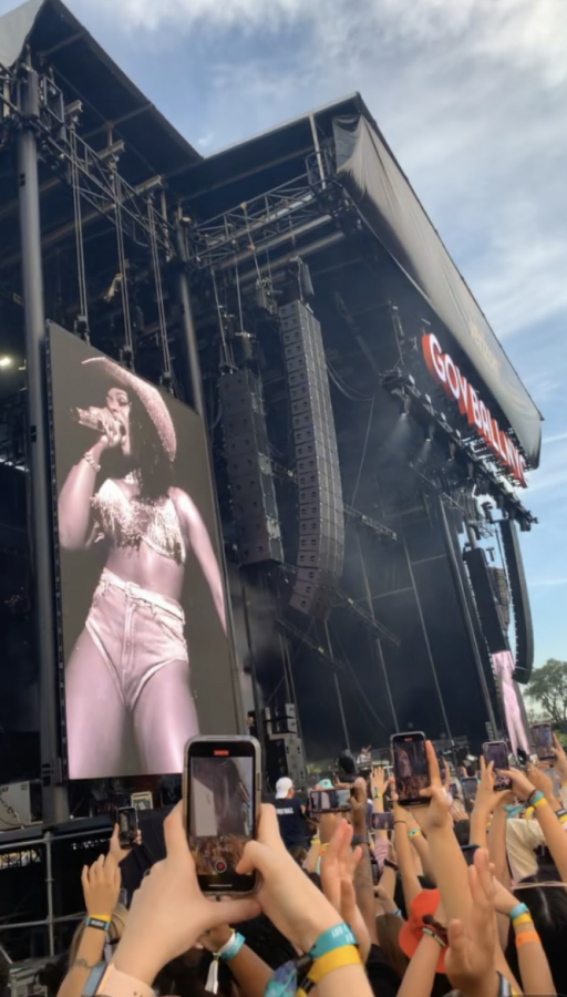 Thousands of people without masks bunch together in mosh pits in order to see artist Megan Thee Stallion. Attendees wear yellow bracelets that indicate proof of a COVID-19 vaccination or a negative test. 