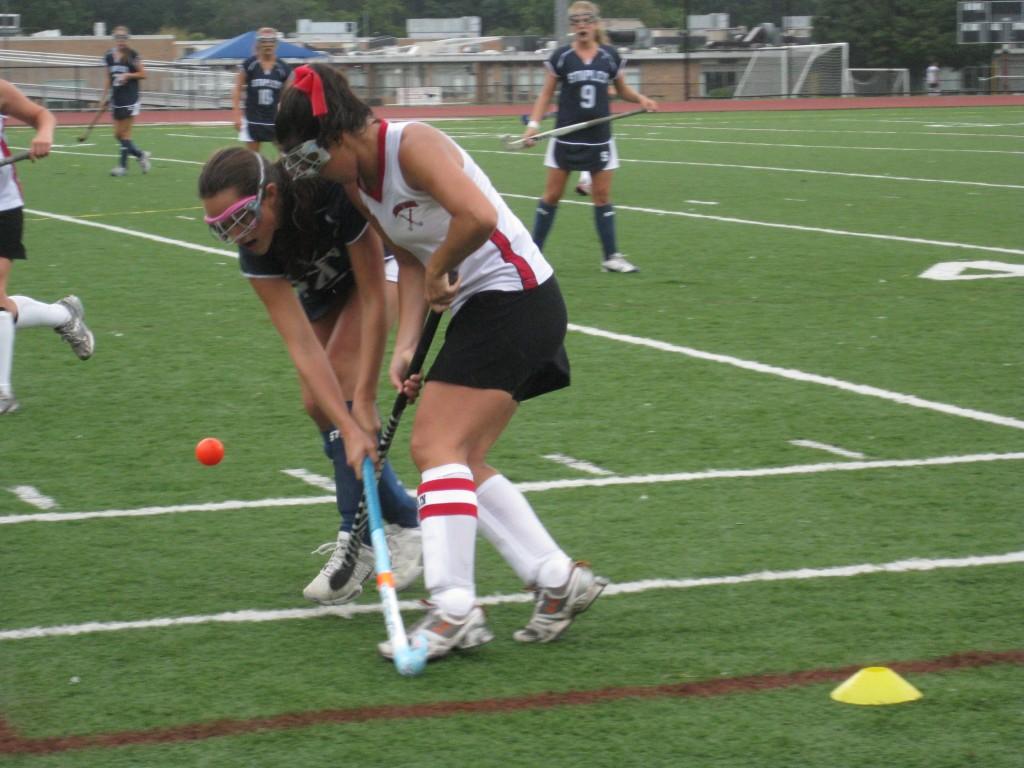 Forward Caroline Steffen 10, fights to bring the ball up the field.