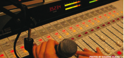 Mixing It Up: A student hosting his radio show adjusts levels on the radio board.