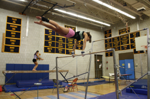 Tri-captain Kara Tricarico 11 practices her routine on the bars. | Photo by Annie Nelson 11