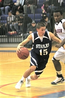 Junior guard Frank Bergonzi drives to the hoop in a recent game against McMahon. Photo courtesy of Staplesbasketball.com (Elaine Rankowitz)