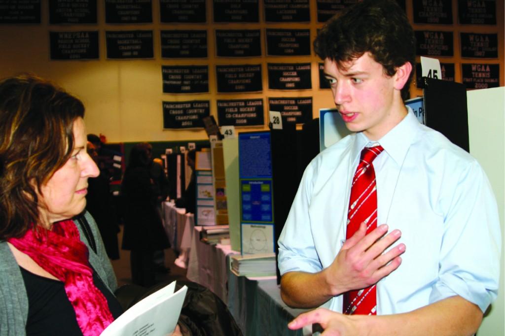 Max Gibson 12 explains his project in front of judges at the 10th annual Southern Connecticut Invitational Science and Engineering Fair at the Convent of the Sacred Heart in Greenwich, Conn. | Photo by Stevie Klein 12