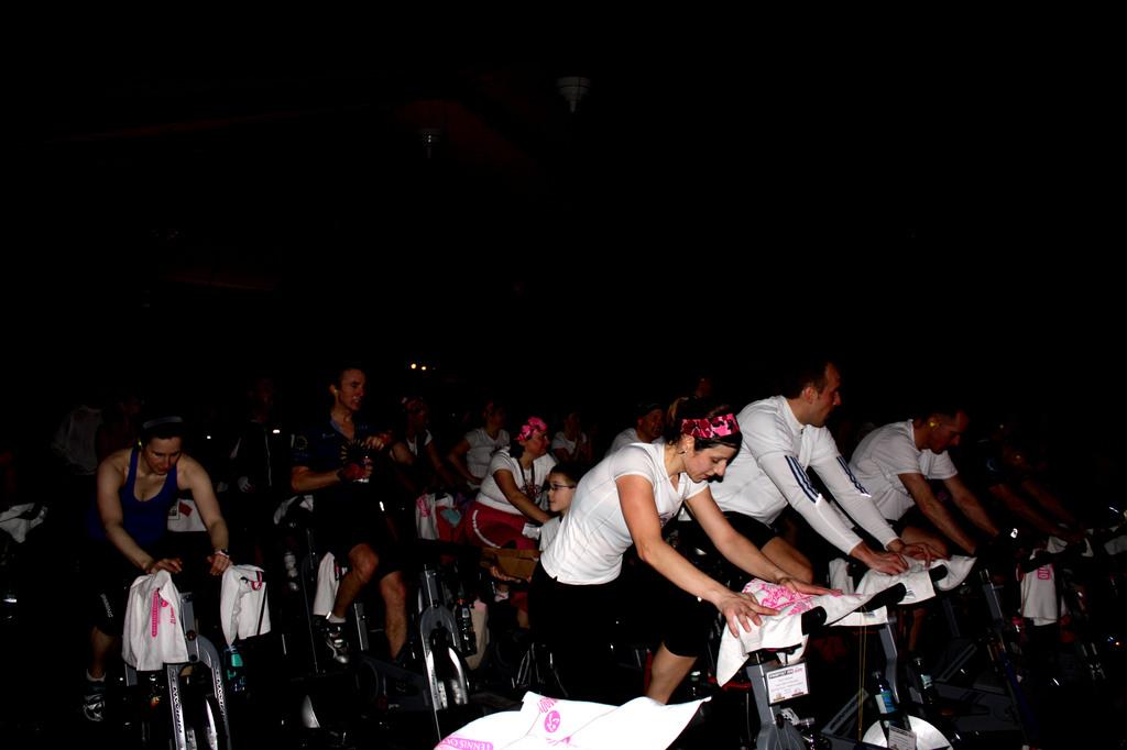 Participants in the Spin Odyssey event exercise on a stationary cycle.  In ten years, this event has raised over 2 million dollars to fund breast cancer research. | Photo by Jordan Ahava 12