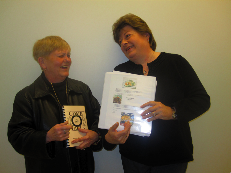 Janice Price (left) and Frances Evan (right) share a laugh over their excitement to put the final touches on the cookbook. | Photo by Devin Skolnick 11
