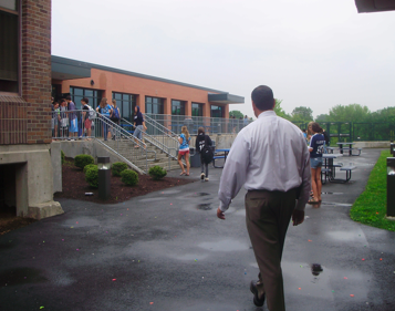 Seniors walk back into the building after Mr. Farnen and other administrators put an end to their water balloon fight in the courtyard. | Photo by Kelsey Landuer 12