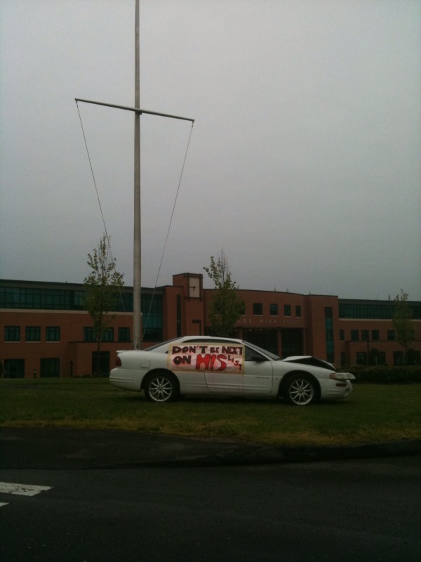 Before student entered school on May 14, the totaled car in front of the school reminded them of Grim Reaper Day, and its message. | Photo by Alix Neenan 12