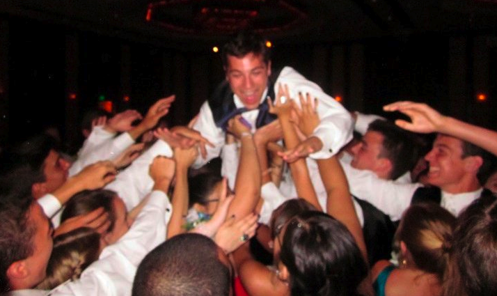 Ian Phillips 10 is one of many students who had a fun filled evening as he crowd-surfs over senior prom attendees. | Photo contributed by Tate Cooper 10 