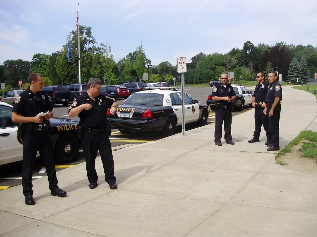 Five Westport Police Officers, including Sgt. Frazier and Officer Loomer on left, familiarize themselves with Staples before all the kids come in. | Photo by Stevie Klein 12