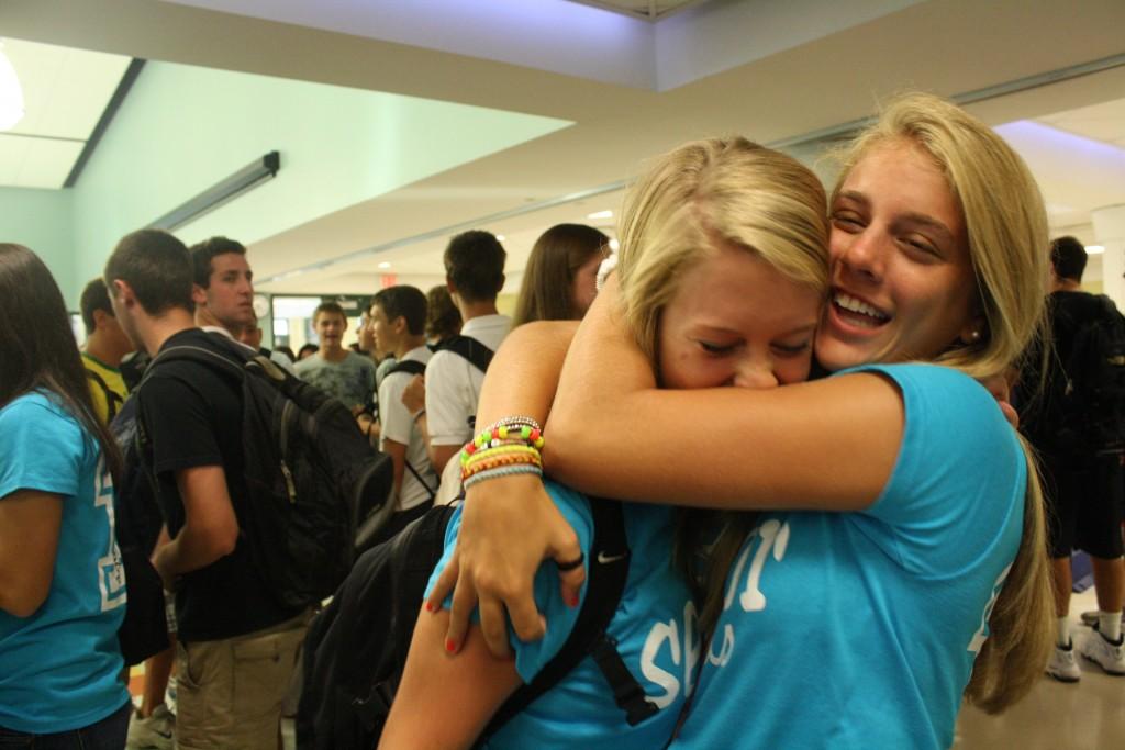 Sammie Hardy 11 (right) embraces Margot Colwell 11 before classes begin on the first day of school.  | Photo by Annie Nelson 11
