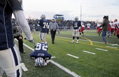 Matt Kelly '10 hunches over in defeat after a valiant effort  against Chesire. | Photo courtesy of Staplesfootball.com