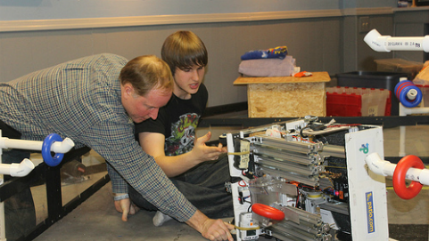Wrecker Robotic co-captain Alec Solder 14 works with his dad John Solder, the teams mentor, on building the robot.