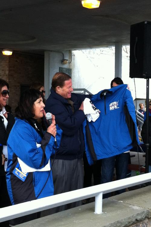 Orna Grand, event organizer for the TBDA, presents senator Richard Blumenthal with a t-shirt and jacket from the TBDA.