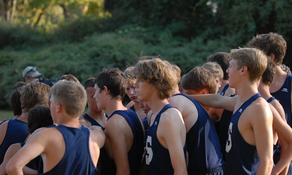 The Boys Cross Country Team huddle before their race.