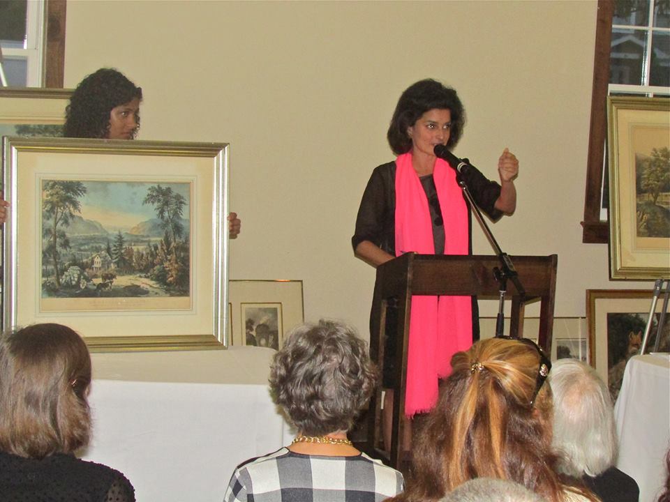 The auctioneer, Jennifer Wright, encourages people to bid for rare prints worth up to $2,000.
