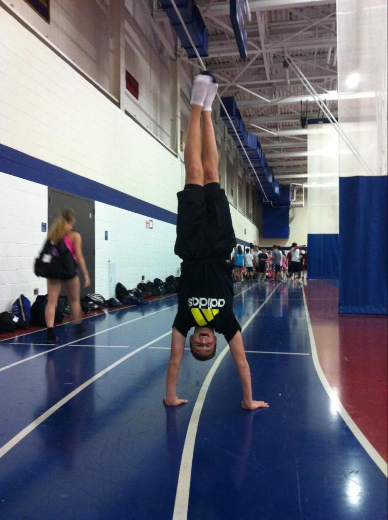 Zach+Wallace+%E2%80%9816+performs+a+handstand+before+cheerleading+practice.
