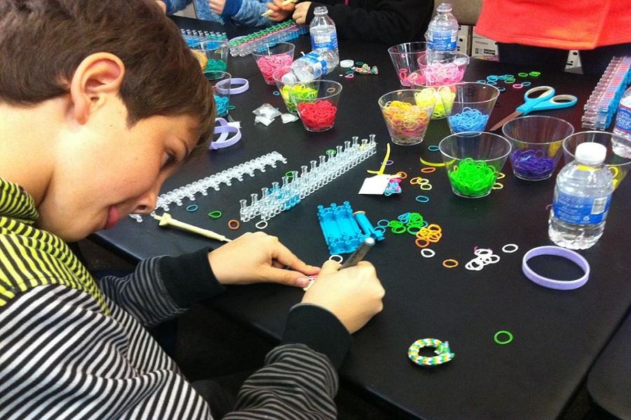 After children made a bracelet, they filled out a card with their name to attach and send with the bracelet. This photo features fourth grader William Burger, who came all the way from New Canaan to make bracelets for the event, filling out a card.