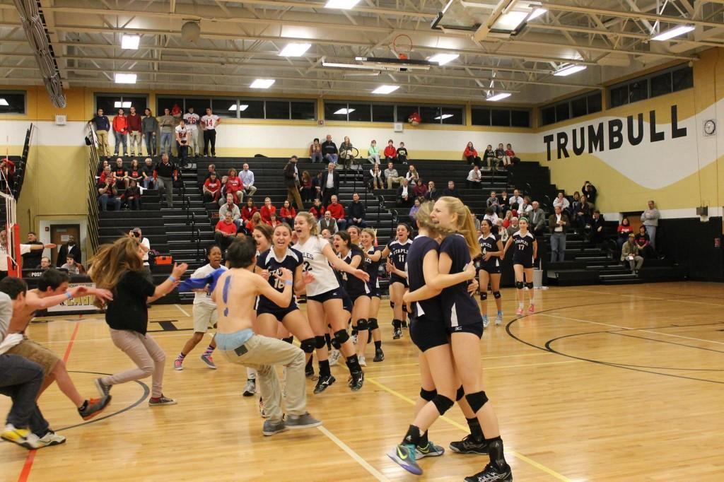 Despite orders from officials to stay in the bleachers, Staples fans rush the court to celebrate the victory.