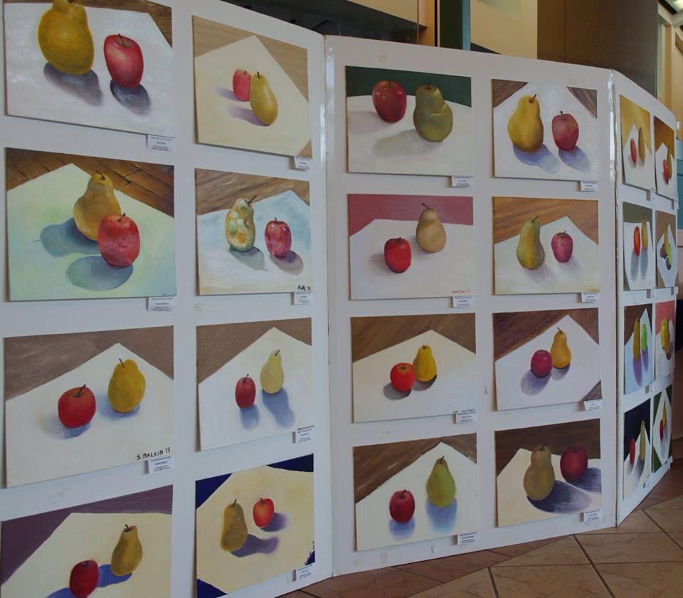 In a Staples oil painting class, students painted pears and apples at a variety of angles, resulting in a whole board of delectable fruit. The difference in styles, brush strokes, shadows, and colors, is dependent upon the individual artist’s approach.