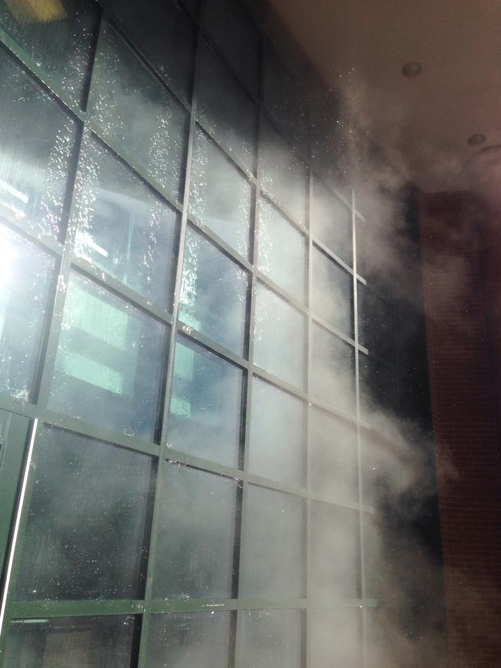 As water poured down the side of the building, mass amounts of steam were created due to the freezing outside temperatures.