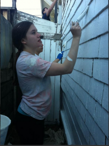 Staples students paint a house in Oakland, CA while on a Temple Israel Senior Youth community service trip.