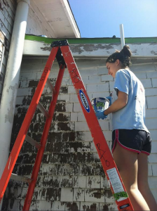Staples students paint a house in Oakland, CA while on a Temple Israel Senior Youth community service trip.