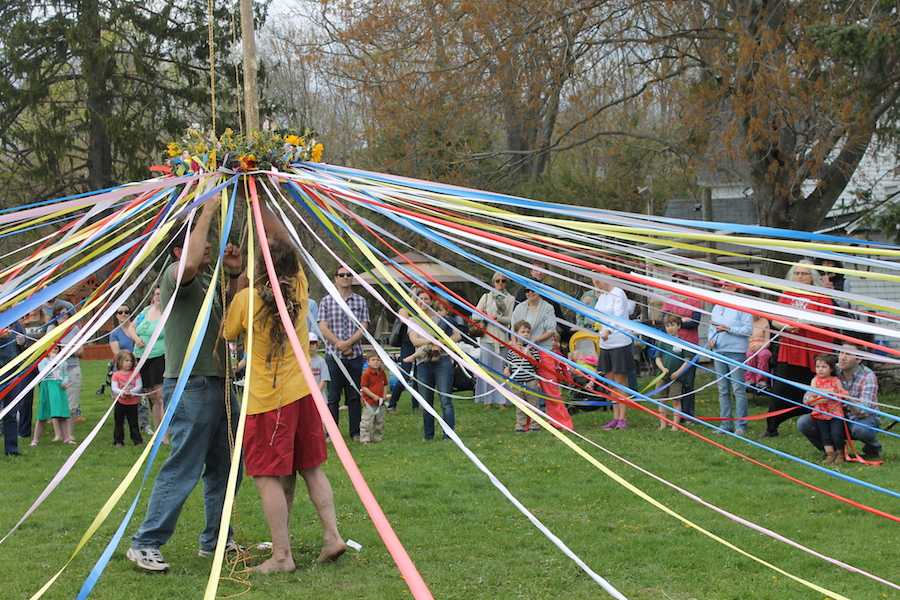 Aitkenhead and Bill Fisher, who leads the maypole dance, raise the maypole up the tree.