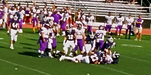 Staples players pile on a Westhill player.