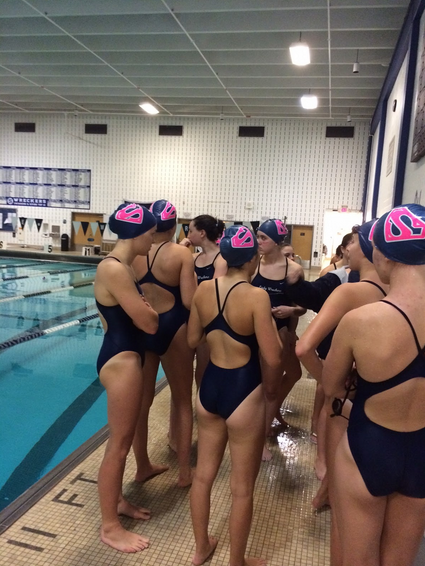 The Lady Wreckers huddled for a pre-meet pep talk