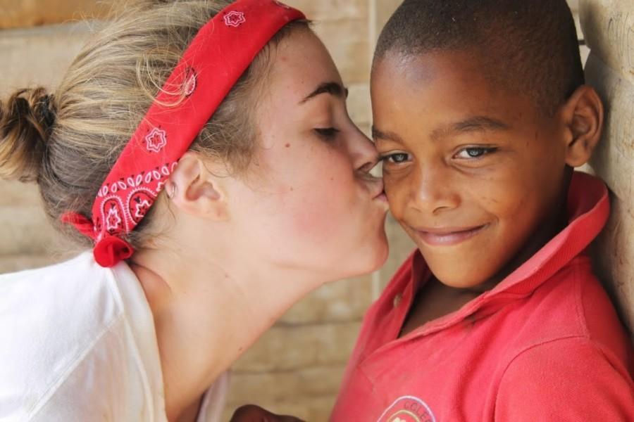 MAKING CONNECTIONS: Members from the group such as Charlotte Rowland ’14 make unbreakable bonds with the children from the Domincan Republic, while building bathrooms for their community. The group plans to continue their work during this February break in Guatemala to help more impoverished communities. 
Photos contributed by Caroline O’Kane ’16