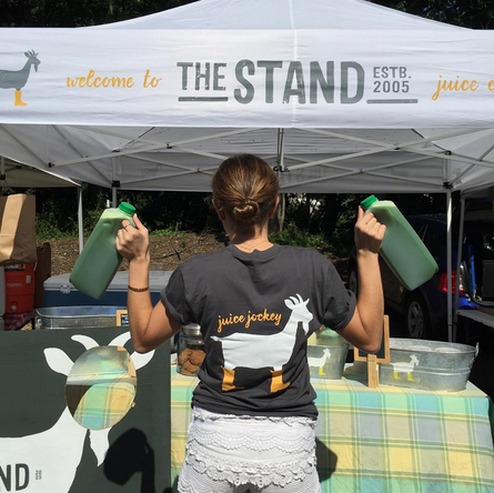 Kowalsky holding “The Stand(ard)” green juice at the Westport Farmer’s Market. 
(Photo contributed by Mikaela Dedona)