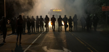 Police officers in Charlotte form a line to control the violent riots and protests